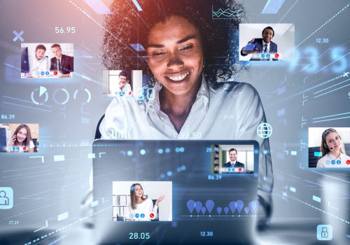 Attractive African American businesswoman using laptop to be a part of video conference call, business colleagues, a team communicating on the distance, hologram digital interface