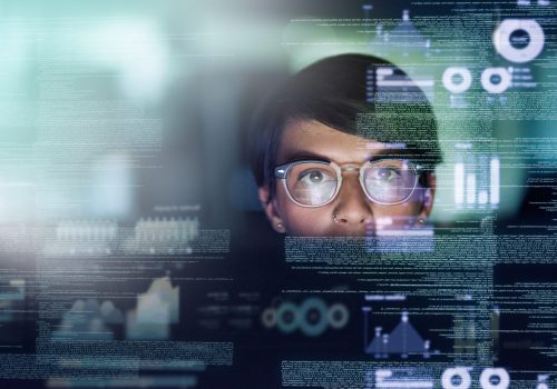 Cropped shot of a young computer programmer looking through data